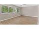 Bright bedroom with wood floors, natural light from large windows, and neutral colored walls at 12992 W Jewell Cir, Lakewood, CO 80228