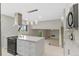 Modern kitchen with white cabinets, an island with countertop seating, and stainless steel appliances at 12992 W Jewell Cir, Lakewood, CO 80228