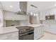 This open kitchen features an island cooktop and stylish pendant lighting at 12992 W Jewell Cir, Lakewood, CO 80228