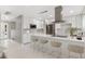 Bright, modern kitchen with white cabinets, stainless steel appliances, and a spacious island at 12992 W Jewell Cir, Lakewood, CO 80228