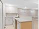 Basement kitchenette featuring white cabinets, a stainless steel sink, and quartz countertops at 12992 W Jewell Cir, Lakewood, CO 80228