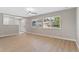 Bright, open living room featuring wood floors, large windows, and neutral paint at 12992 W Jewell Cir, Lakewood, CO 80228