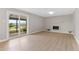 Spacious living room with sliding glass doors that lead to a patio with mountain views at 12992 W Jewell Cir, Lakewood, CO 80228