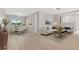 Open-concept living and dining area with modern furnishings and abundant natural light at 12992 W Jewell Cir, Lakewood, CO 80228