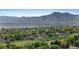 Scenic neighborhood view nestled among lush trees, offering a serene living environment with majestic mountain views at 12992 W Jewell Cir, Lakewood, CO 80228