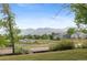 Scenic neighborhood view with lush greenery and distant mountain scenery at 12992 W Jewell Cir, Lakewood, CO 80228