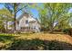 Exterior rear view of home with large backyard, rock foundation, and mature trees at 4850 S Kittredge St, Aurora, CO 80015