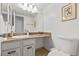 Bathroom featuring a vanity with marble countertops, a mirror, and a toilet at 4850 S Kittredge St, Aurora, CO 80015