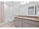Bathroom featuring a double sink vanity with a light countertop, bathtub, shower and tile floors at 4850 S Kittredge St, Aurora, CO 80015