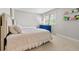 Bright bedroom with two beds, blue dresser, and window with natural light at 4850 S Kittredge St, Aurora, CO 80015