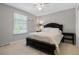 Comfortable bedroom with a dark wooden bed frame, and natural light from the window at 4850 S Kittredge St, Aurora, CO 80015