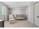 Neutral Bedroom featuring a crib, chair with ottoman, closet, and bright window at 4850 S Kittredge St, Aurora, CO 80015