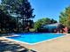 Bright blue community pool with lounge chairs and a pool house for residents at 4850 S Kittredge St, Aurora, CO 80015