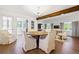 Elegant dining room with wood beam accent, modern lighting, and access to a sunroom at 4850 S Kittredge St, Aurora, CO 80015