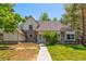 Charming two-story home boasts stone accents, a well-maintained lawn, and mature trees at 4850 S Kittredge St, Aurora, CO 80015