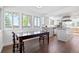 Bright kitchen and dining area featuring hardwood floors, white cabinets and stainless steel appliances at 4850 S Kittredge St, Aurora, CO 80015