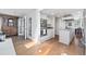 Open concept kitchen with double ovens, hardwood floors and access to a dining space at 4850 S Kittredge St, Aurora, CO 80015
