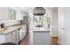 Modern kitchen with stainless steel appliances, granite countertops, and a center island cooktop at 4850 S Kittredge St, Aurora, CO 80015