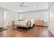 Spacious main bedroom with hardwood floors, a ceiling fan, and an ensuite bathroom at 4850 S Kittredge St, Aurora, CO 80015