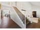 Elegant staircase with white railings and hardwood steps leading to the upper level at 4850 S Kittredge St, Aurora, CO 80015