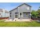 Gray two-story home featuring a spacious backyard and patio area perfect for outdoor entertaining at 748 Poppywood Pl, Highlands Ranch, CO 80126