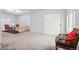 Basement living area featuring a comfortable couch, woven chair, sliding closet, and bright carpet at 748 Poppywood Pl, Highlands Ranch, CO 80126