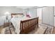 Bedroom featuring wood-framed bed, decorative rug, neutral paint, and natural light at 748 Poppywood Pl, Highlands Ranch, CO 80126