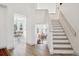 Spacious foyer leading to dining and living areas, featuring modern flooring and ample natural light at 748 Poppywood Pl, Highlands Ranch, CO 80126