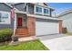 Inviting entrance with a bright red door, American flag, and a cozy porch, creating a welcoming feel at 748 Poppywood Pl, Highlands Ranch, CO 80126