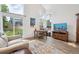 Bright living room with large windows, sliding doors leading to a backyard, couch, and a television at 748 Poppywood Pl, Highlands Ranch, CO 80126