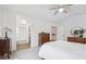 Spacious main bedroom with neutral colors, vaulted ceiling, fan, and attached bathroom at 748 Poppywood Pl, Highlands Ranch, CO 80126