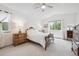 Bright main bedroom featuring vaulted ceiling, neutral colors, a ceiling fan, and wooden furniture at 748 Poppywood Pl, Highlands Ranch, CO 80126