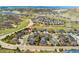 Aerial view of homes in community; features green hills, neighborhood streets, and mountain views in distance at 627 Millbrook Cir, Castle Rock, CO 80109