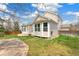 Well-maintained backyard with stone patio, green lawn, and view of the home's light siding and many windows at 627 Millbrook Cir, Castle Rock, CO 80109