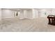 Expansive basement with neutral tones, plush carpeting, and natural light from a large window at 627 Millbrook Cir, Castle Rock, CO 80109