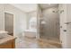 Bathroom with modern tub, glass shower, and a window allowing natural light at 627 Millbrook Cir, Castle Rock, CO 80109