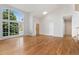 Spacious living room with hardwood floors and large grid windows at 627 Millbrook Cir, Castle Rock, CO 80109