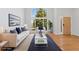Bright living room with hardwood floors, large windows, and comfortable seating at 627 Millbrook Cir, Castle Rock, CO 80109