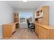 Dedicated office space featuring built-in shelving, carpet, and a standard window at 627 Millbrook Cir, Castle Rock, CO 80109