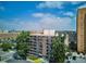 Wide aerial view of an apartment building with balconies, a parking lot, and some landscaping under a bright blue sky at 4801 E 9Th Ave # 402S, Denver, CO 80220