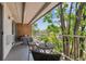 Spacious outdoor balcony featuring wrought iron furniture and scenic tree view at 4801 E 9Th Ave # 402S, Denver, CO 80220