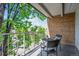 Outdoor balcony featuring wrought iron furniture and beautiful neighborhood and tree view at 4801 E 9Th Ave # 402S, Denver, CO 80220