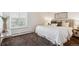 Comfortable bedroom featuring a plush bed, soft carpeting, and sunny windows at 4801 E 9Th Ave # 402S, Denver, CO 80220