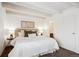 Comfortable bedroom featuring a large bed, bedside tables and attached bathroom at 4801 E 9Th Ave # 402S, Denver, CO 80220