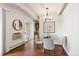 Cozy dining area with modern lighting fixture, table, chairs, and view into kitchen at 4801 E 9Th Ave # 402S, Denver, CO 80220