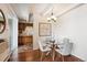 Cozy dining area with modern lighting fixture, table, chairs, and view into kitchen at 4801 E 9Th Ave # 402S, Denver, CO 80220
