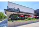 Hopdoddy Burger Bar features a stylish exterior with red umbrellas and inviting ambiance at 4801 E 9Th Ave # 402S, Denver, CO 80220