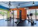 Well-equipped gym with weight machines and recumbent bike with a view from large window at 4801 E 9Th Ave # 402S, Denver, CO 80220