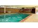 Inviting indoor swimming pool with brick accent wall and ample lighting for year-round enjoyment at 4801 E 9Th Ave # 402S, Denver, CO 80220