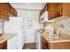 Bright kitchen featuring tile backsplash, countertops, wooden cabinets, and modern appliances at 4801 E 9Th Ave # 402S, Denver, CO 80220